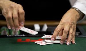 A dealer shuffles a deck of cards during a round of Texas Hold 'em at the World Series of Poker, Friday, May 31, 2013, in Las Vegas.