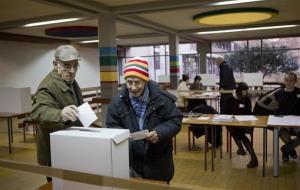 Voters cast their ballots at a polling station in Zagreb, Croatia, Sunday, Jan. 11, 2015.