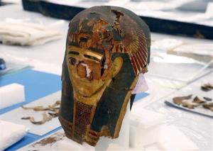 The burial mask of Minirdis, a 14-year-old Egyptian boy who was the son of a priest, is positioned for conservation work Wednesday, Dec. 10, 2014, in Chicago. 